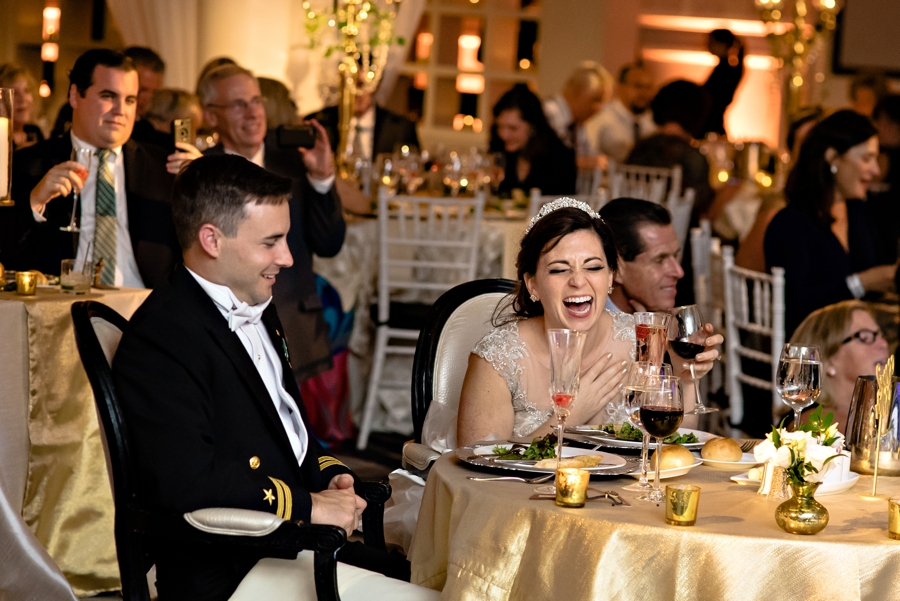 A Bride laughing at her bridesmaids speeches.